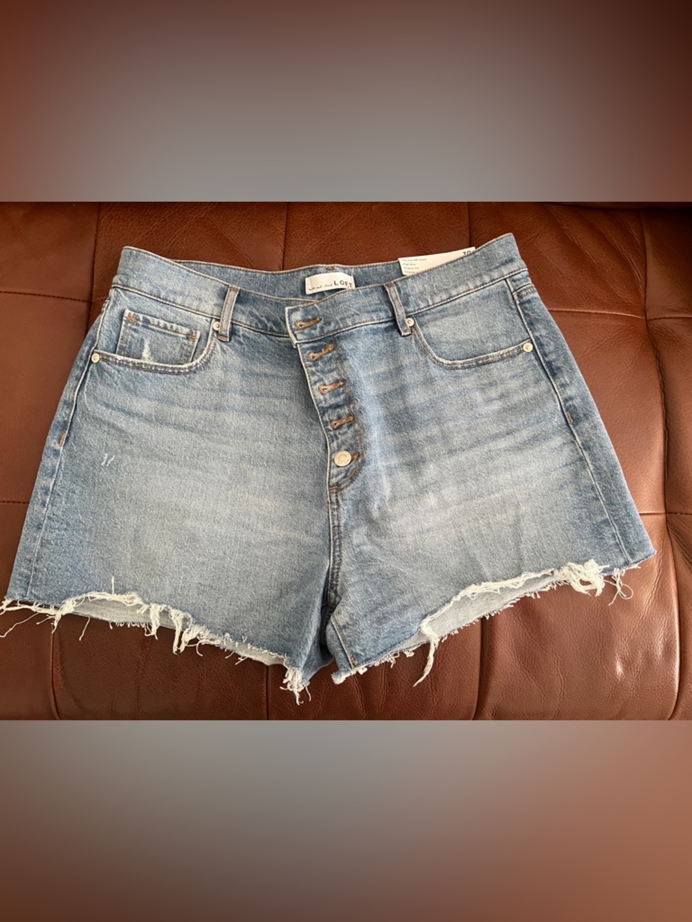 LOFT Button Front High Rise Destructed Cut Off Denim Shorts in Mid Indigo Wash
